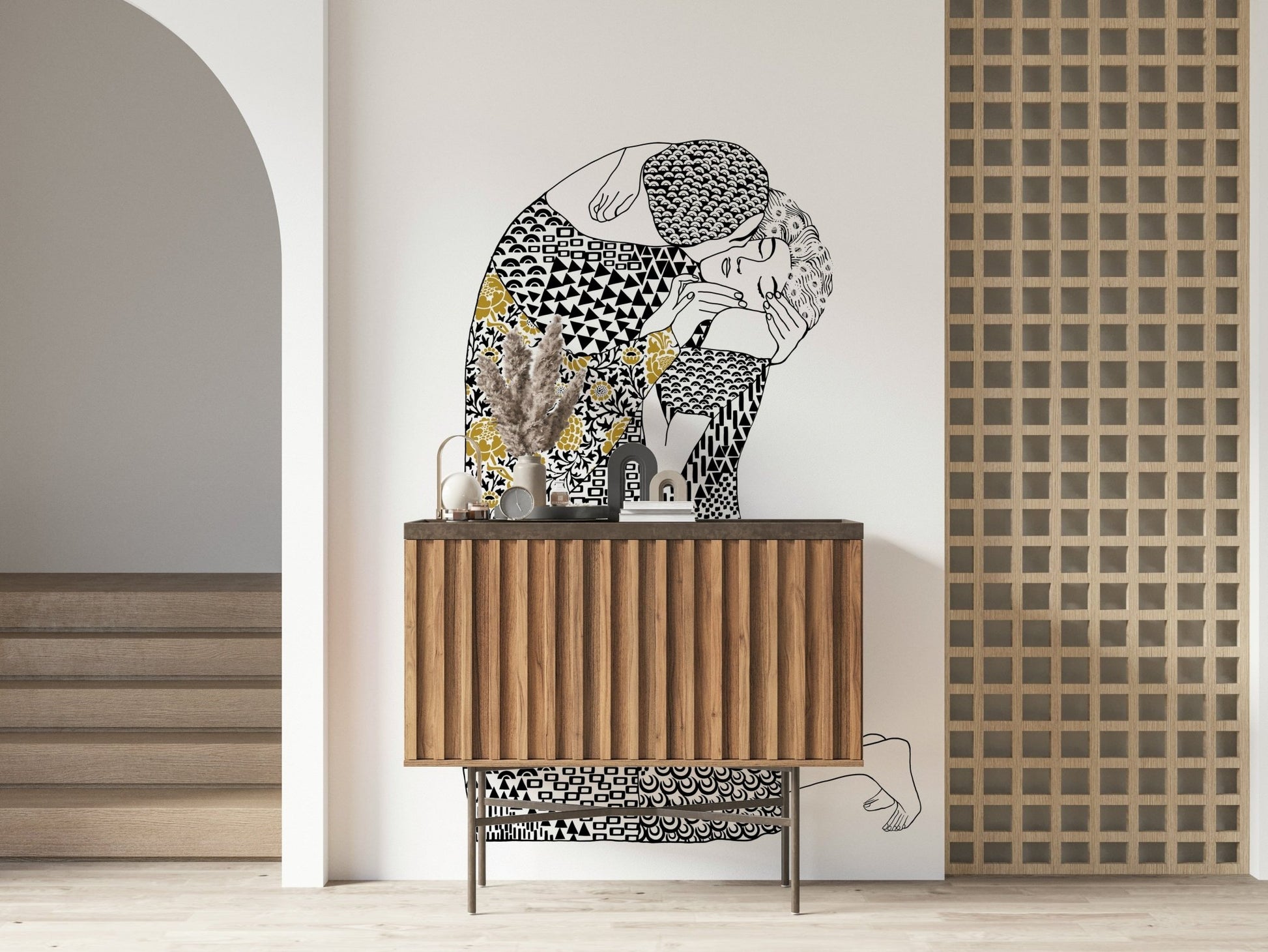 The Kiss wallpaper mural of a kissing couple above a fluted wood sideboard in an entryway