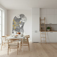 The Kiss wallpaper mural in black white and gold behind a marble dining table and wishbone chairs
