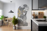 The Kiss wallpaper mural in monochrome behind a wood breakfast nook beside a gray kitchen