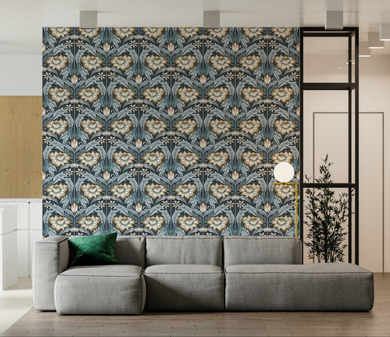 Timeless Garden Midnight Blue wallpaper with navy and gold damask florals behind a grey sectional sofa in a living room