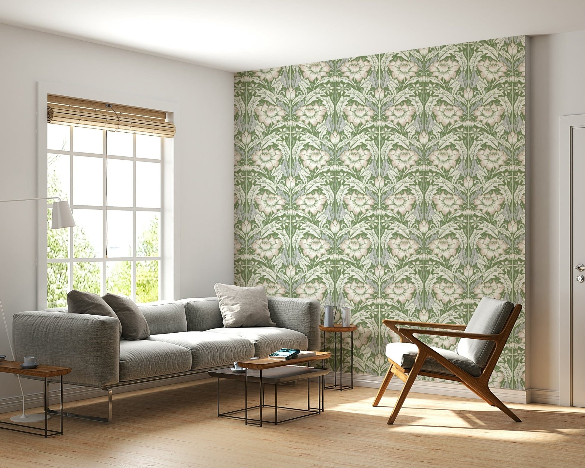 Timeless Garden Sage Green wallpaper of sage floral damask behind a grey sofa and wood armchair by a window