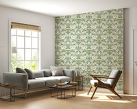 Timeless Garden Sage Green wallpaper of sage floral damask behind a grey sofa and wood armchair by a window