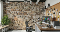 Timeless Stonework wallpaper mural in rounded tan fieldstone behind a desk with dual monitors in a home office