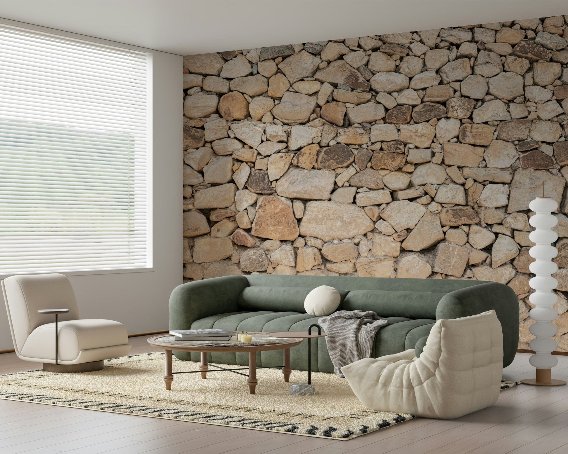 Timeless Stonework wallpaper mural of tan fieldstone behind a green sofa and cream chair in a bright living room