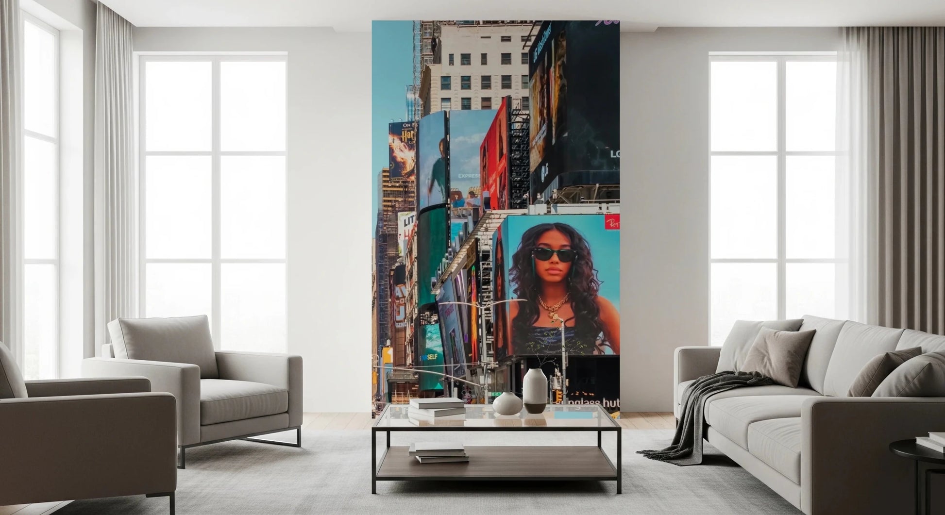 Times Square Buzz wallpaper mural of towering colorful billboards between a gray sofa and armchair in a living room