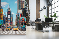 Times Square Buzz wallpaper mural of NYC taxis and billboards beside desks and black chairs in an open-plan office