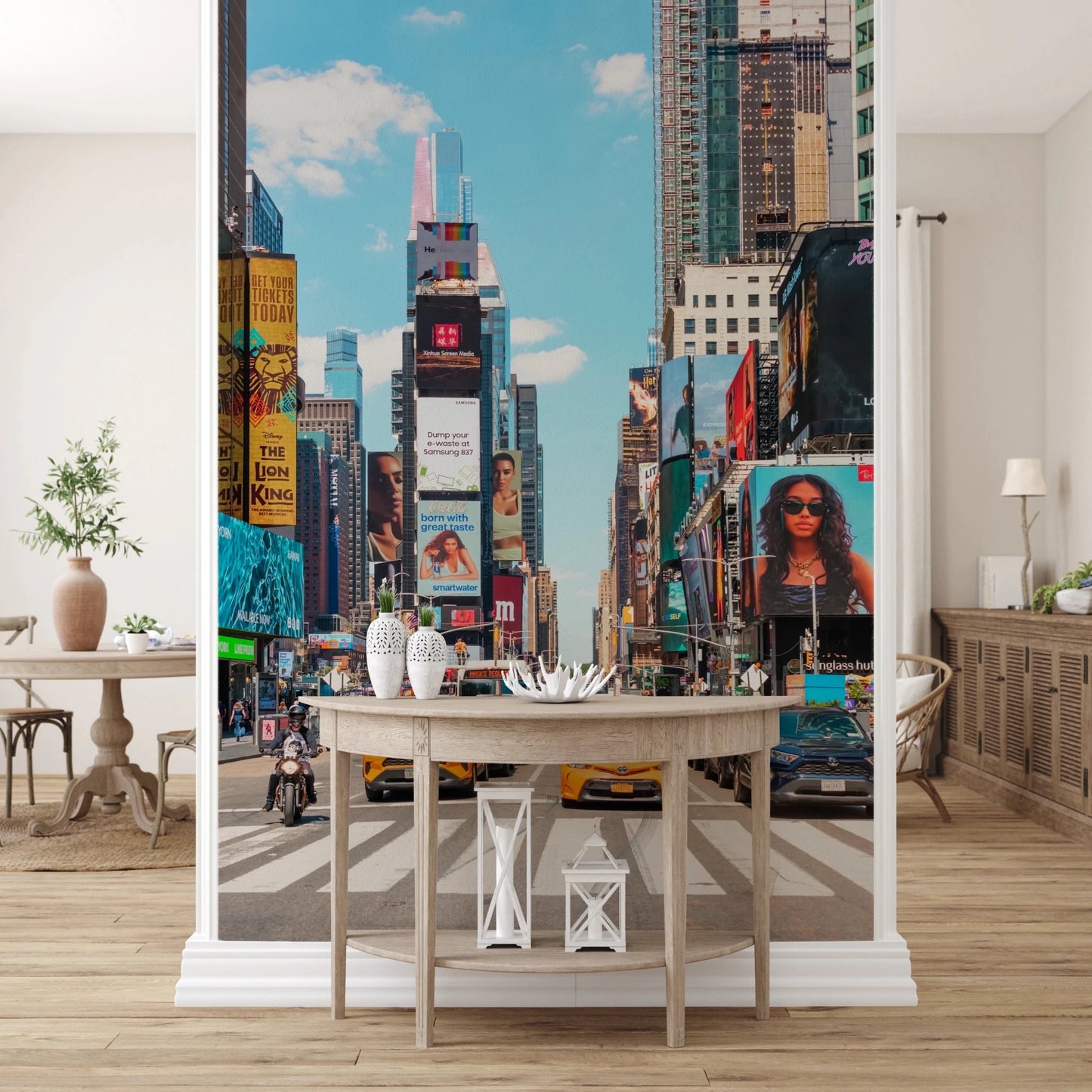 Times Square Buzz wallpaper mural of Times Square billboards framed by columns above a white console in an entryway