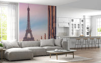 Tour Eiffel Sunset wallpaper mural of the Eiffel Tower behind a grey sectional sofa beside a white kitchen