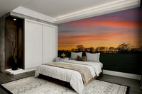 Serenity in Shadows wallpaper mural of a golden sunset field behind a low bed with white bedding in a bedroom