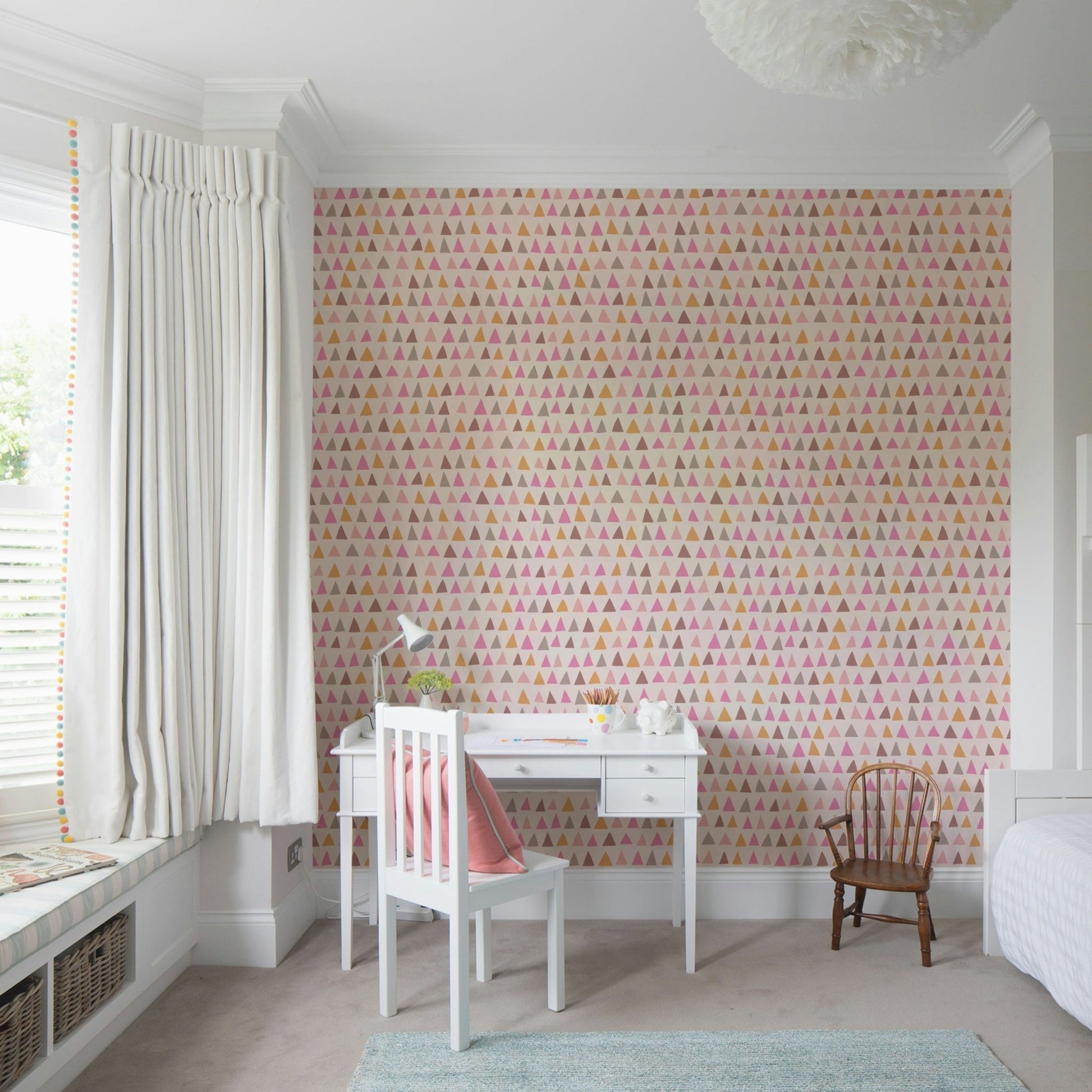 Blush-toned triangle wallpaper for girls’ rooms or creative spaces.

