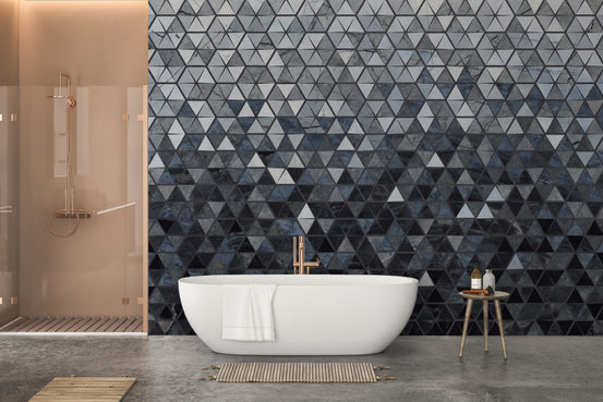 Blue Cut Triangle Tiles wallpaper mural in a bathroom behind a freestanding white tub and copper-framed glass shower