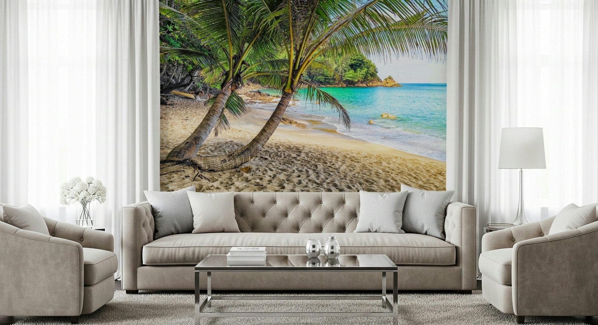 Tropical Beach Escape wallpaper mural of a palm-fringed beach behind a beige tufted sofa and armchairs in a living room