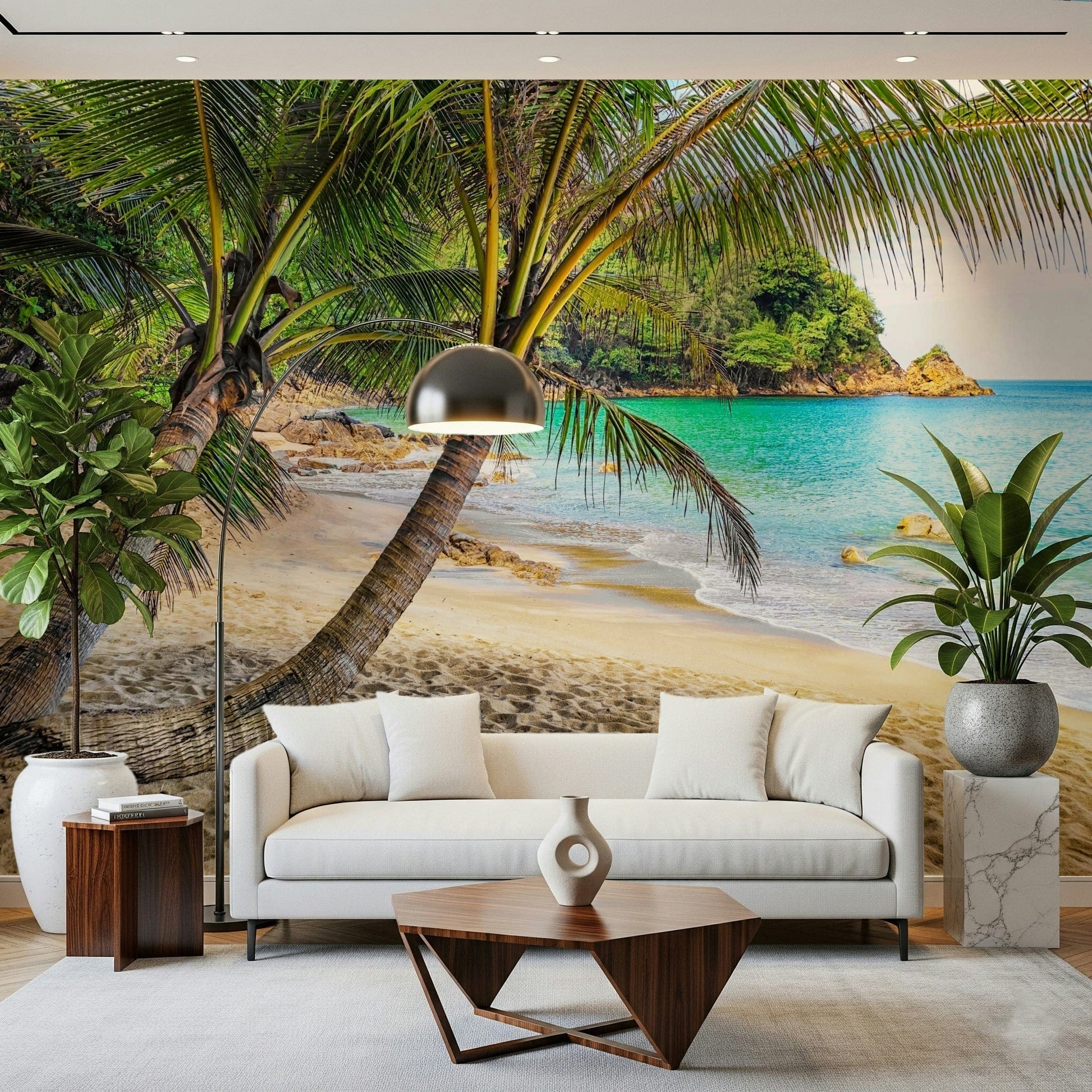 Tropical Beach Escape wallpaper mural of leaning palms over a lagoon behind a cream sofa and dome floor lamp