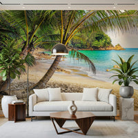 Tropical Beach Escape wallpaper mural of leaning palms over a lagoon behind a cream sofa and dome floor lamp