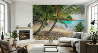 Tropical Beach Escape wallpaper mural of a turquoise cove behind a white sectional and lit fireplace in a living room