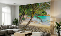 Tropical Beach Escape wallpaper mural of a palm beach behind a grey sectional and wood coffee table in a living room