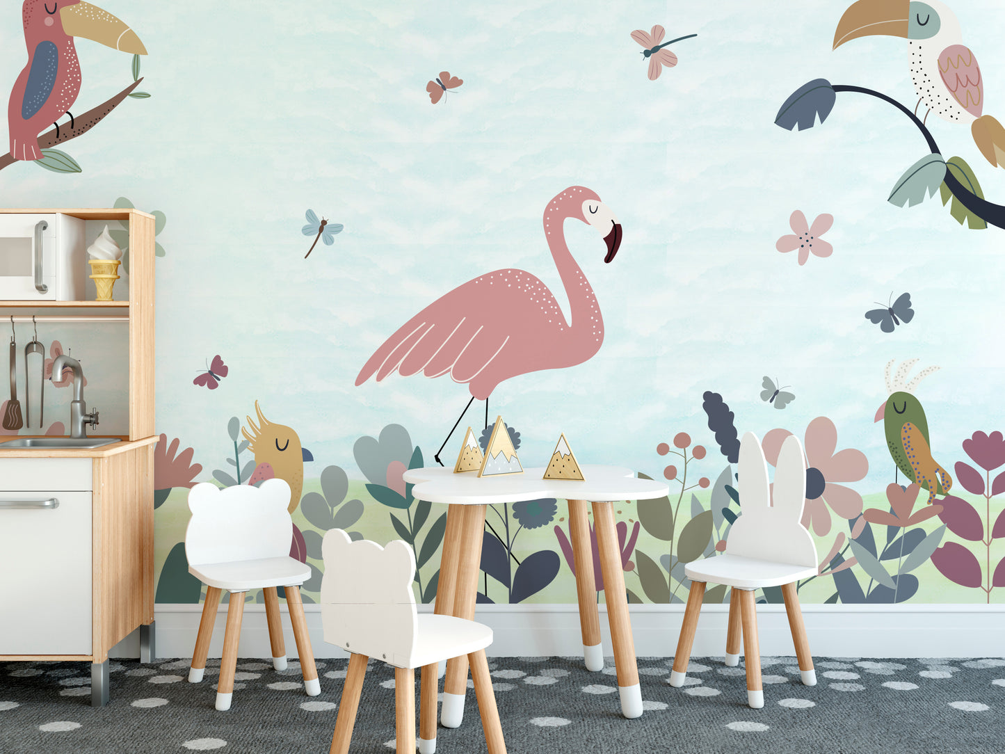 Tropical Bird wallpaper of flamingo and toucans in a kids playroom with white animal chairs and a toy kitchen