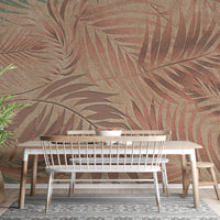 Tropical Copper Leaves wallpaper mural in copper and tan palm fronds behind a wood table and white bench in a dining room
