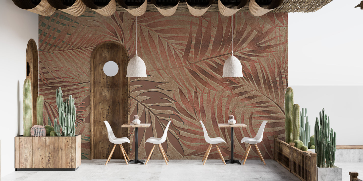 Tropical Copper Leaves wallpaper mural of rust and tan palm fronds behind white chairs and cacti in a cafe seating area