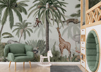 Tropical jive wallpaper mural with giraffe and elephant beside a green velvet armchair in a jungle kids room