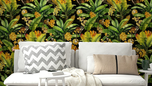 Close-up of monkeys among tropical leaves and colorful blossoms.

