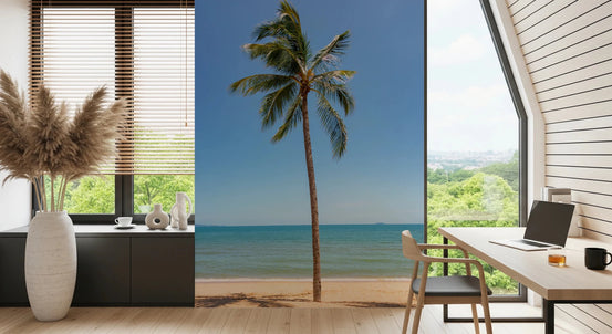 Tropical Retreat wallpaper mural of a tall beach palm tree behind a wood desk and laptop in a home office