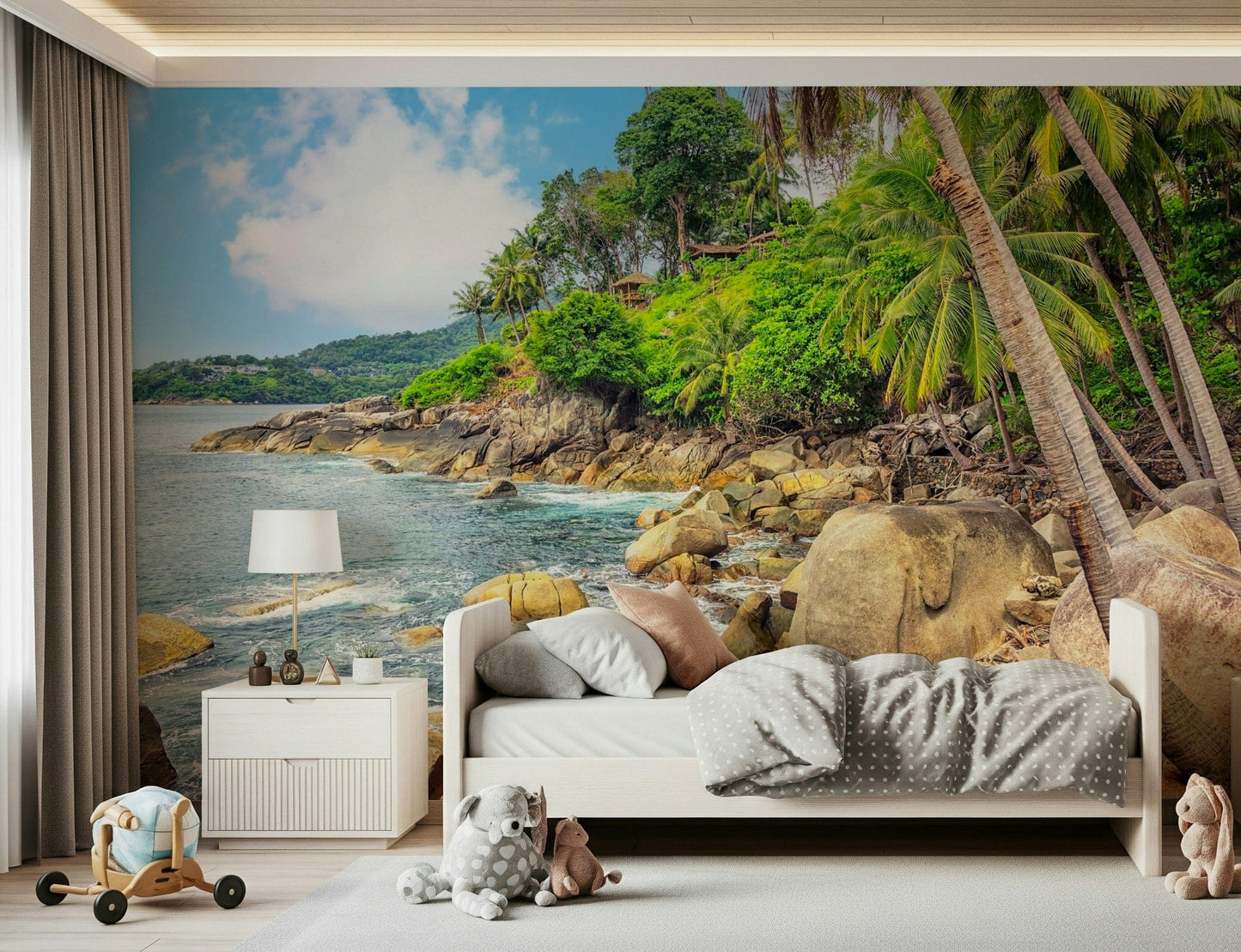 Tropical Shores wallpaper mural of a palm coastline above a single bed with plush toys in a child's bedroom