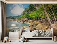 Tropical Shores wallpaper mural of a palm coastline above a single bed with plush toys in a child's bedroom