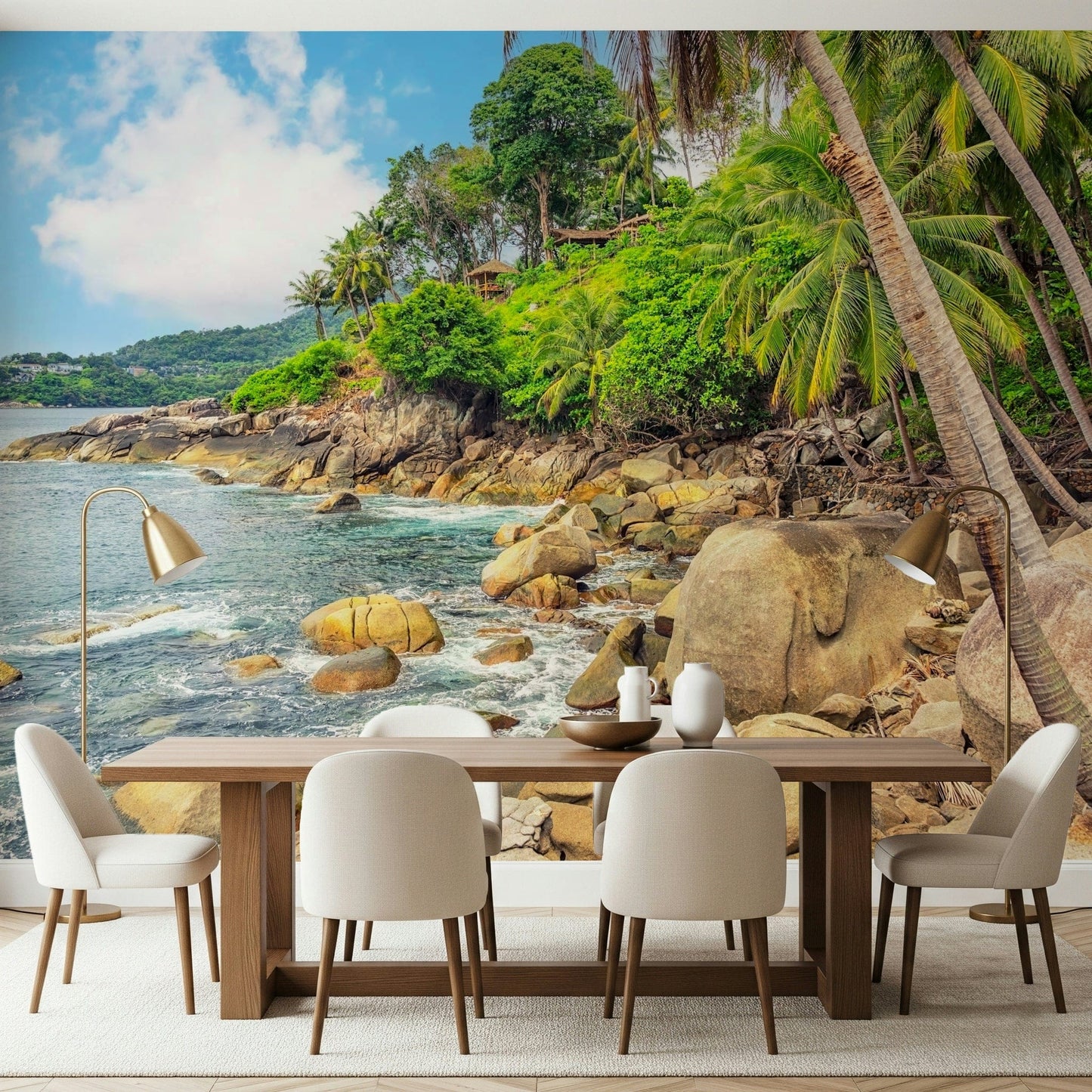 Tropical Shores wallpaper mural of a rocky palm bay behind a wood dining table and cream chairs in a dining room