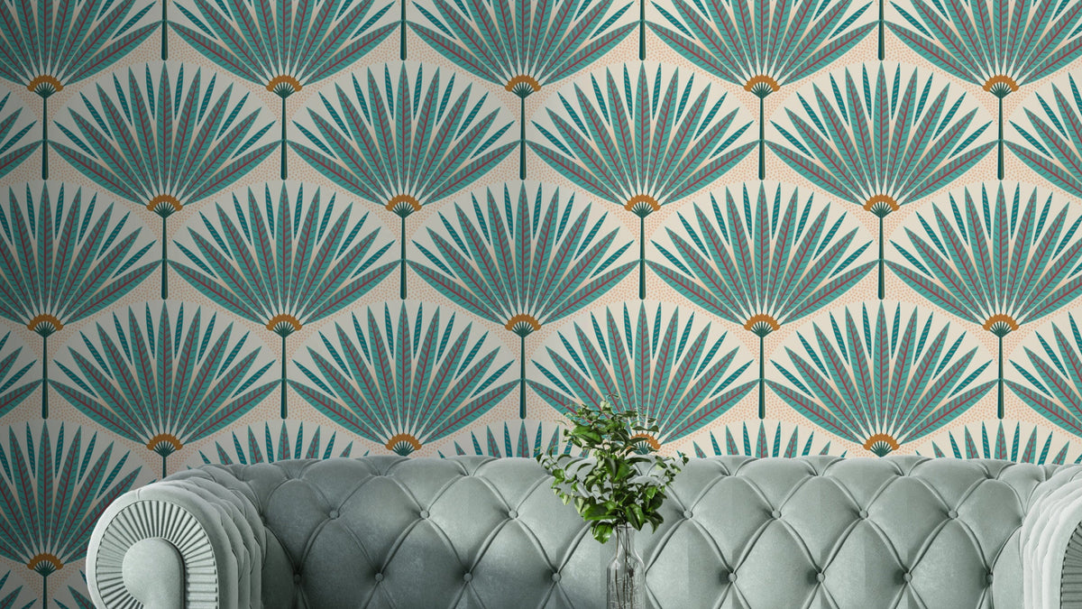 Tropical Teal Paradise wallpaper mural with Art Deco palm fans behind a tufted sage velvet sofa in a living room
