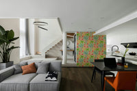 The colors are soft, muted tones of green, fuchsia, orange, and blue.

