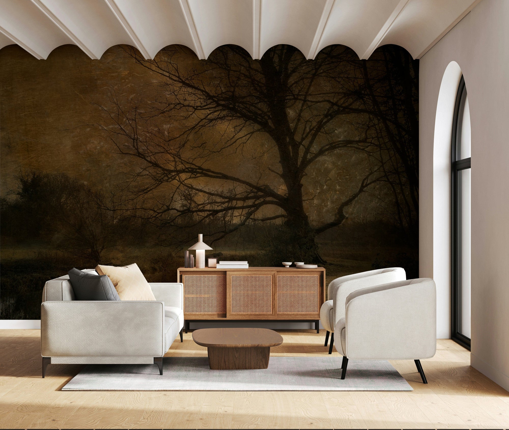 Golden Grove Twilight wallpaper mural of a bare tree at dusk behind a grey sofa and cane sideboard