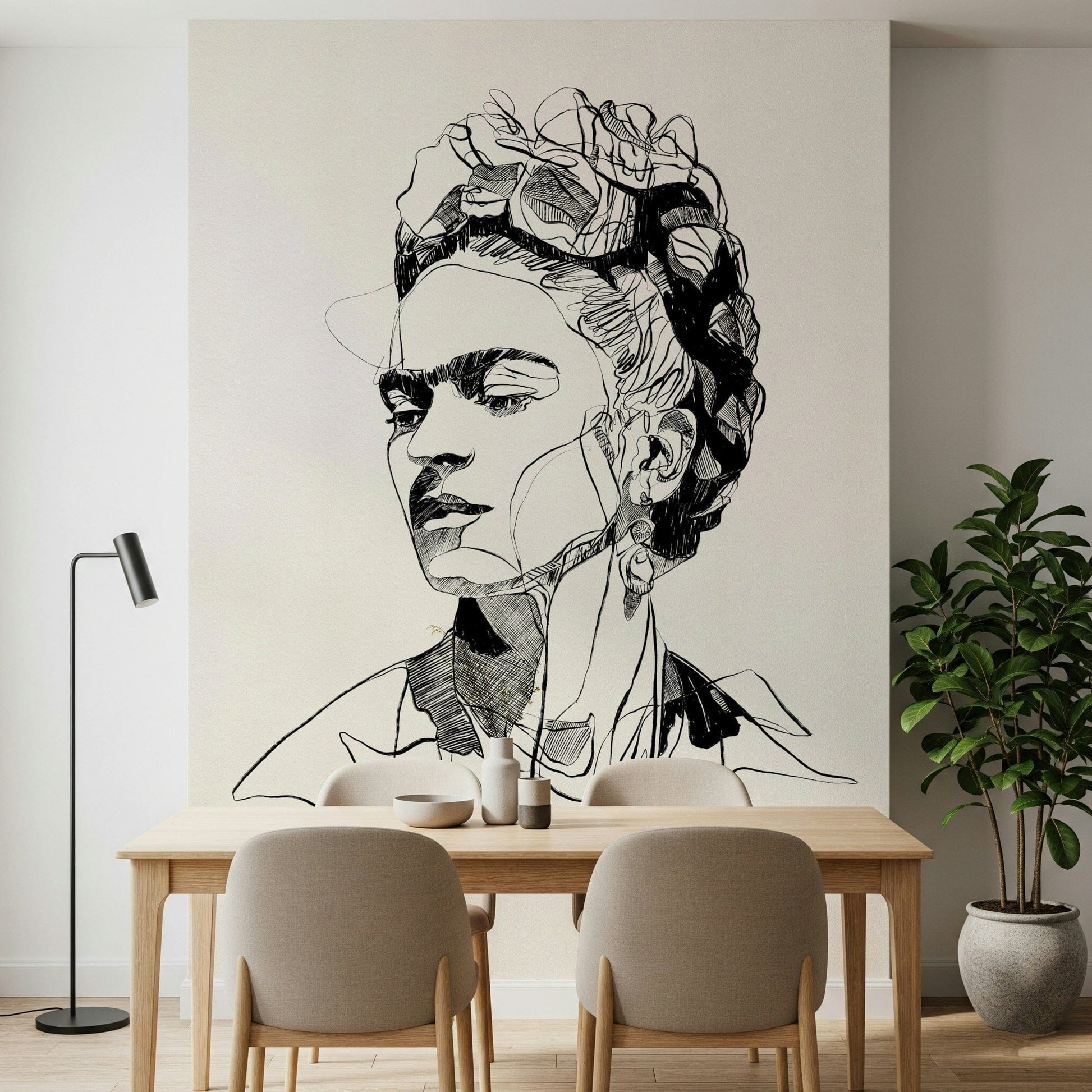 Unbroken wallpaper mural with a black line portrait above a wood dining table and beige chairs