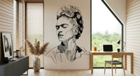 Unbroken wallpaper mural with a sketched portrait beside a wood desk and laptop in a home office