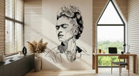 Unbroken wallpaper mural of a black ink portrait beside a wood desk and arched window in a home office