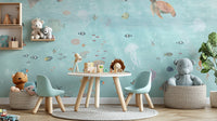 Underwater Marine Life wallpaper mural with jellyfish and turtles above teal chairs and a plush grey elephant