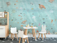 Underwater Marine Life wallpaper mural with turtles and clownfish behind white kids chairs and a toy kitchen
