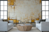 Urban Blocks wallpaper mural of gold and beige plaster squares between two white armchairs and a round wood table in a living room