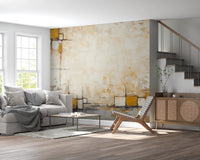 Urban Blocks wallpaper mural of yellow and beige abstract squares behind a grey sofa and cane sideboard near a staircase