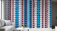 Urban Gridlock wallpaper mural of red and blue high-rise windows behind a white sofa in a modern living room