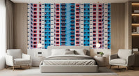 Urban Gridlock wallpaper mural of stacked red and blue windows behind a grey bed flanked by cream armchairs