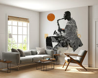 Urban Jazz wallpaper mural of a saxophonist with orange sun behind a grey sofa and wood-frame armchair