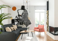 Urban Jazz wallpaper mural of a saxophonist with orange sun behind a dark grey sectional and coral armchair
