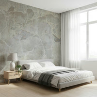 Urban Texture wallpaper mural in gray concrete behind a white bed and wood nightstand by sheer curtains