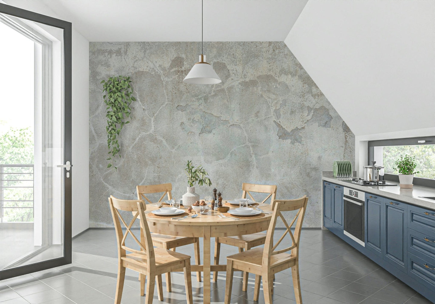 Urban Texture wallpaper mural in gray plaster behind a round wood dining table in a kitchen with blue cabinets