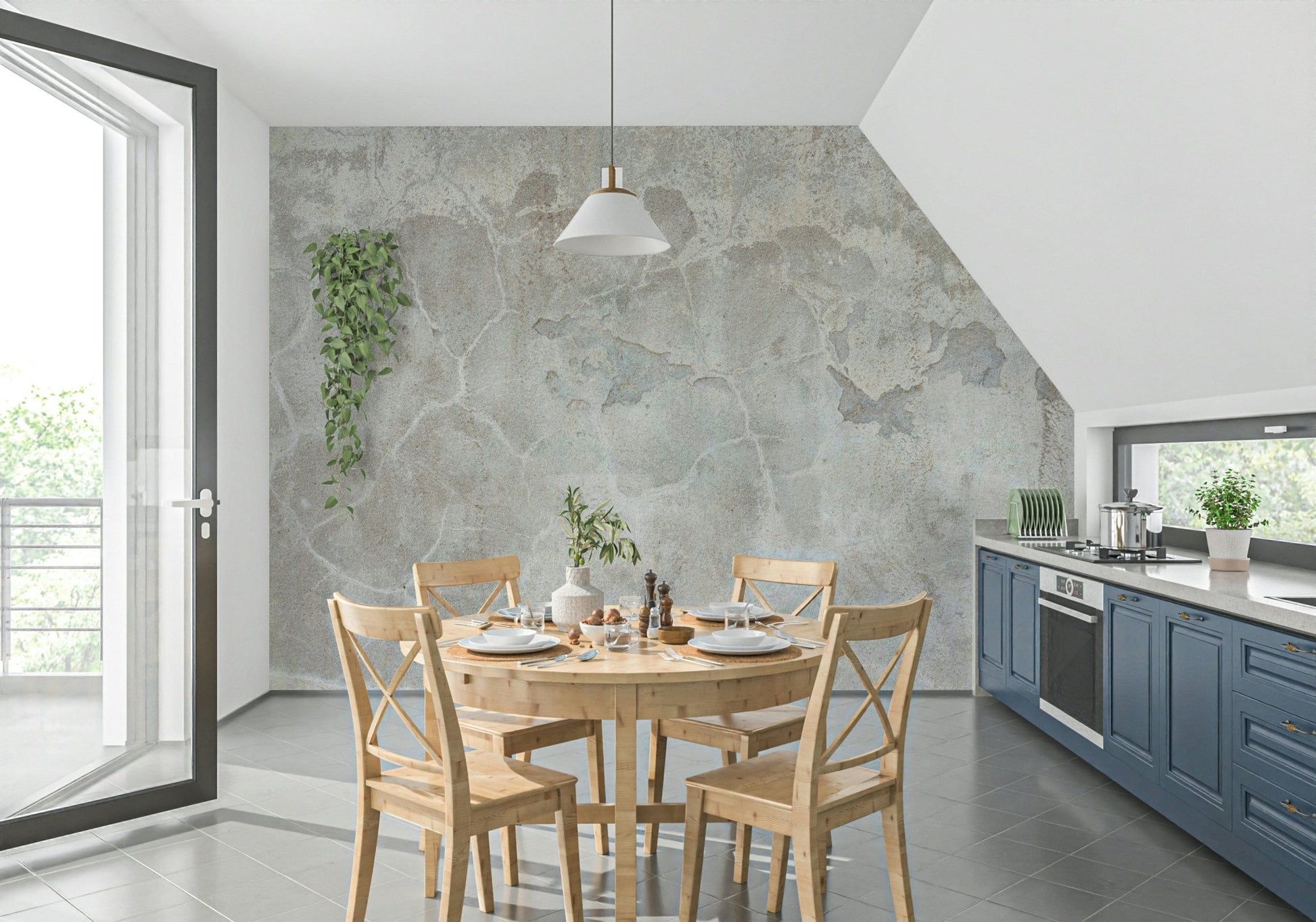 Urban Texture wallpaper mural in gray plaster behind a round wood dining table in a kitchen with blue cabinets