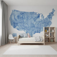 USA map with states and capitals in blue watercolor wallpaper mural in a kids bedroom with a wood bed and toy shelf