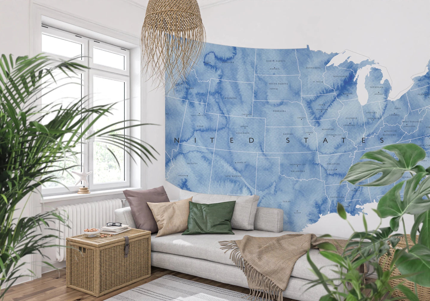 USA map with states and capitals in blue watercolor wallpaper mural behind a grey daybed with a rattan pendant