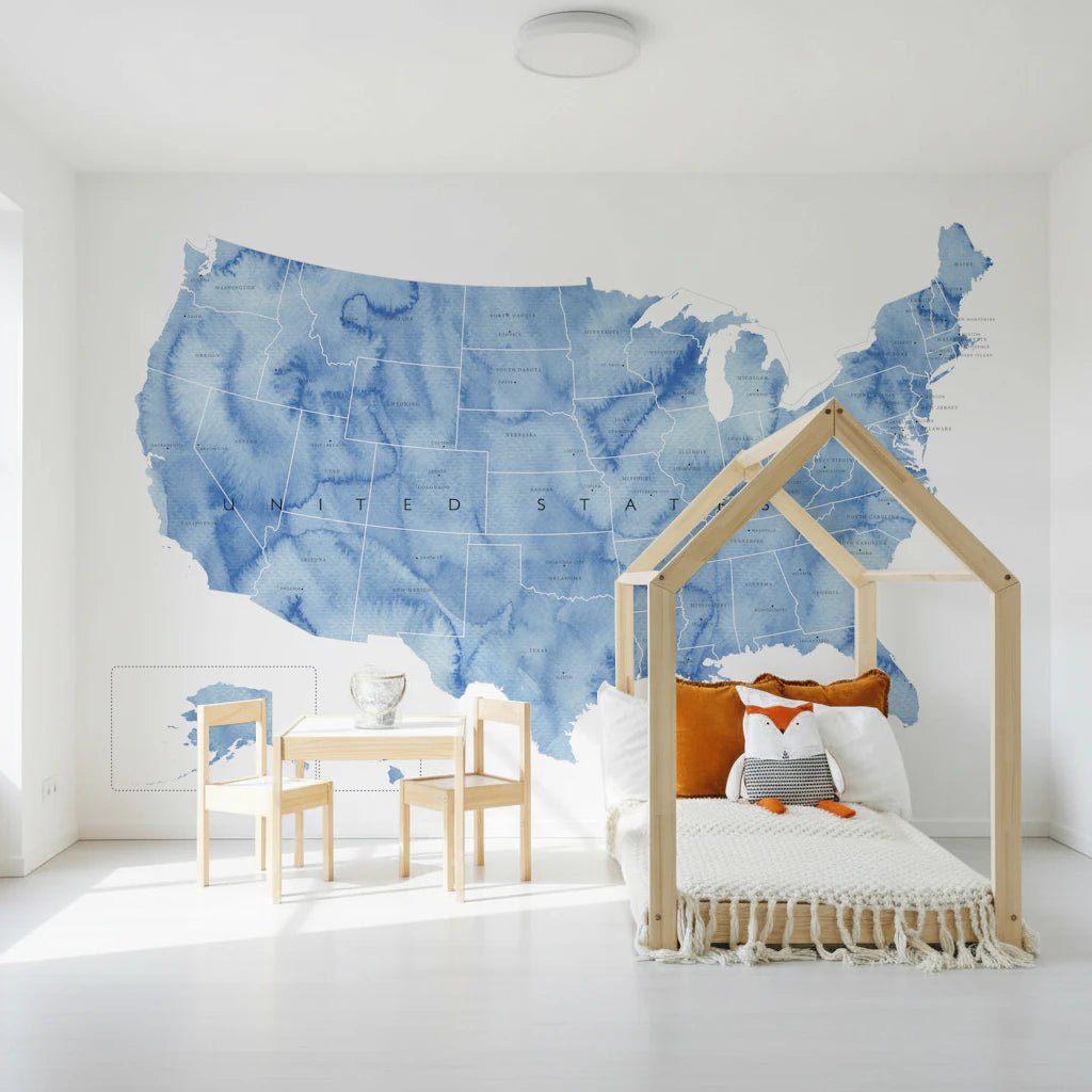 USA map with states and capitals in blue watercolor wallpaper mural in a kids room with a house-frame bed and fox toy