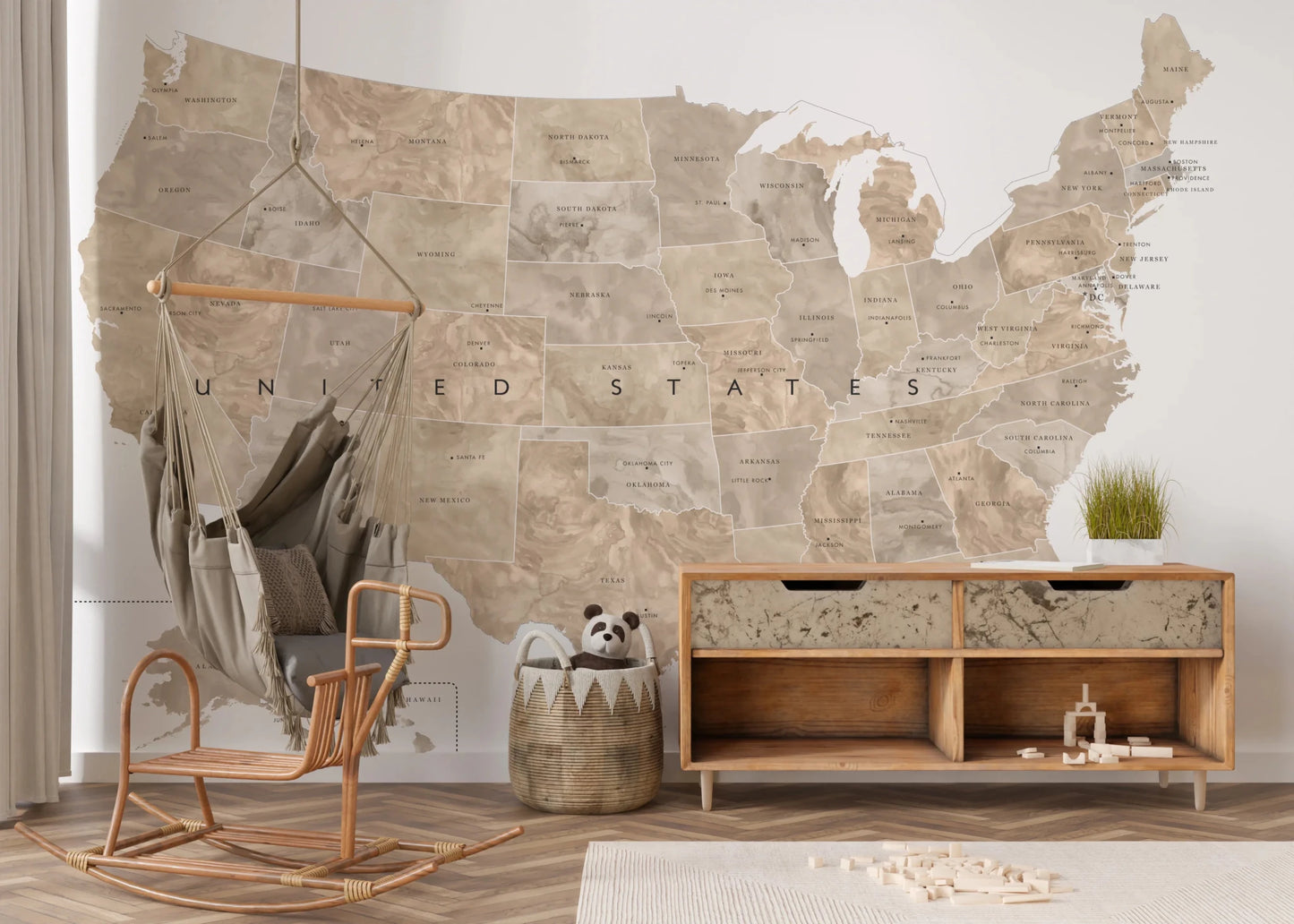 USA map with states and capitals in tan watercolor wallpaper mural in a kids room with a swing chair and credenza